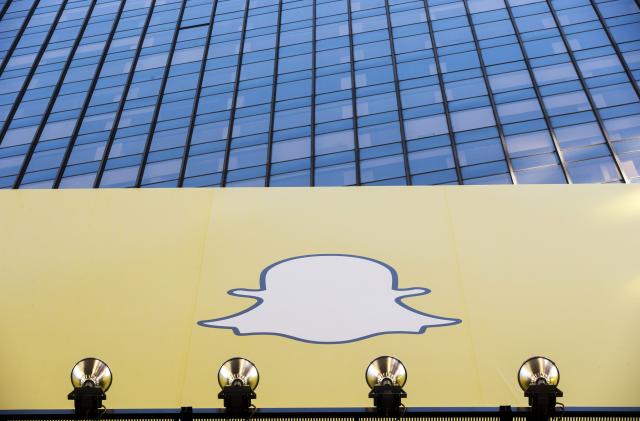 A billboard displays the logo of Snapchat above Times Square in New York March 12, 2015. REUTERS/Lucas Jackson (UNITED STATES - Tags: SOCIETY BUSINESS)