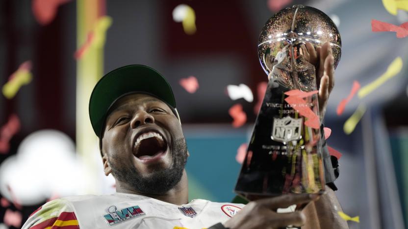 Kansas City Chiefs defensive end Carlos Dunlap celebrates with the Vince Lombardi Trophy after the NFL Super Bowl 57 football game, Sunday, Feb. 12, 2023, in Glendale, Ariz. The Kansas City Chiefs defeated the Philadelphia Eagles 38-35. (AP Photo/Ashley Landis)