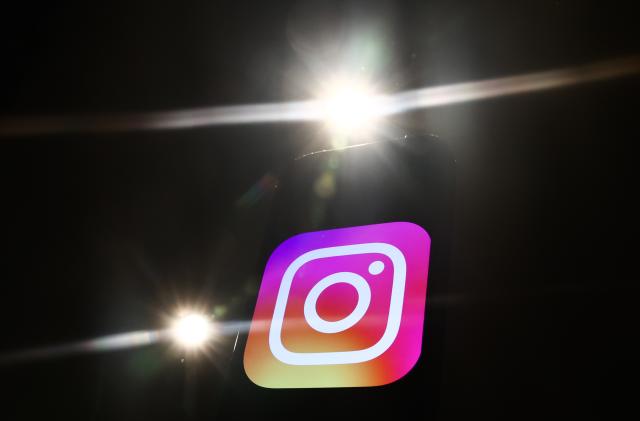 Lights and Instagram logo displayed on a phone screen are seen in this illustration photo taken in Krakow, Poland on December 27, 2023. (Photo by Jakub Porzycki/NurPhoto via Getty Images)