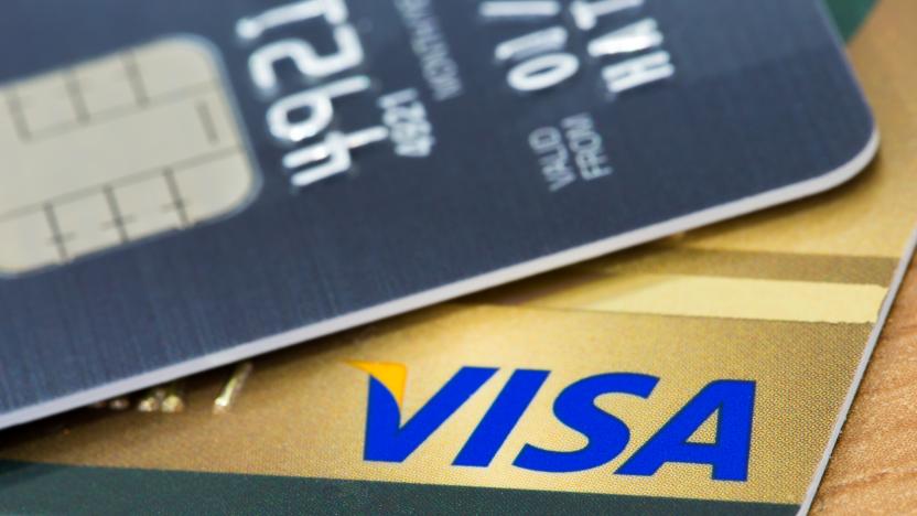 BANGKOK, THAILAND - February 27, 2014: Closeup of VISA credit card with smart ship on wood texture background. VISA is one of the three biggest brands.