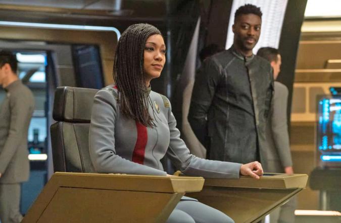 The captain sits on the bridge in the captain's chair in this scene from Star Trek: Discovery.