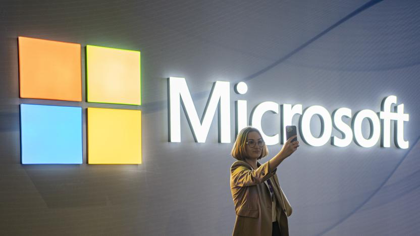 FILE - A visitor takes a photo at the Microsoft stand at Mobile World Congress 2024 in Barcelona, Spain, Feb. 27, 2024. New European Union rules aimed at preventing tech companies from dominating digital markets will change what people see online starting Thursday, March 7, 2024. (AP Photo/Pau Venteo, File)