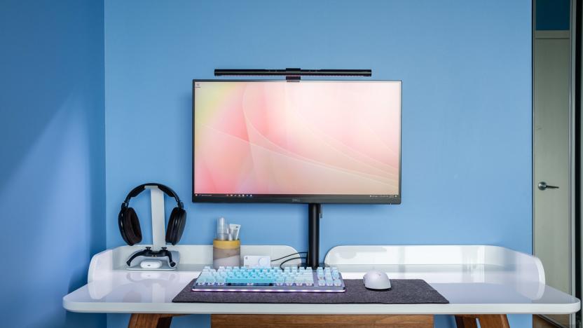 Photo of desk with a BenQ Screenbar mounted to a 27-inch monitor. 