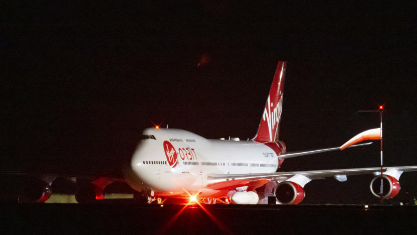 NEWQUAY, ENGLAND - JANUARY 09: A general view of Cosmic Girl, a repurposed Boeing 747 aircraft carrying the LauncherOne rocket under its left wing, as final preparations are made at Cornwall Airport Newquay on January 9, 2023 in Newquay, United Kingdom. Virgin Orbit launches its LauncherOne rocket from the spaceport in Cornwall, marking the first ever orbital launch from the UK. The mission has been named Start Me Up after the Rolling Stones hit. (Photo by Matthew Horwood/Getty Images)