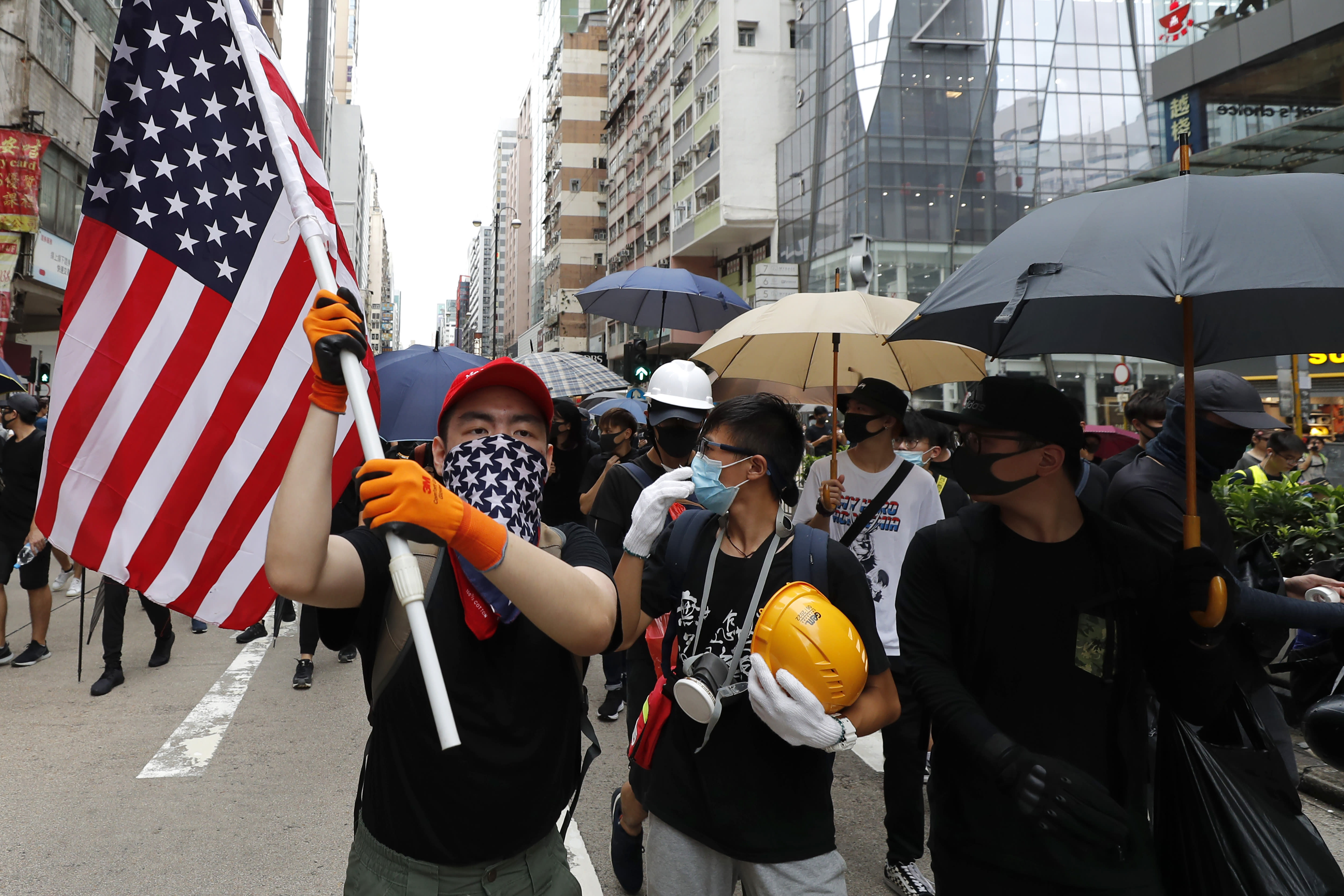 Hong Kong protesters toss Chinese flag, clash with police