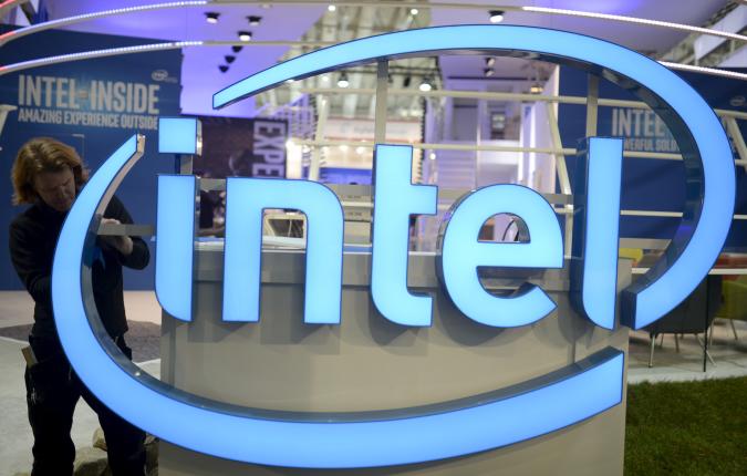 A worker arranges an Intel logo at the CeBIT trade fair, the world's biggest computer and software fair, in Hannover in this March 13, 2016, file photo.  REUTERS/Nigel Treblin/Files  GLOBAL BUSINESS WEEK AHEAD PACKAGE - SEARCH 'BUSINESS WEEK AHEAD APRIL 18'  FOR ALL IMAGES
