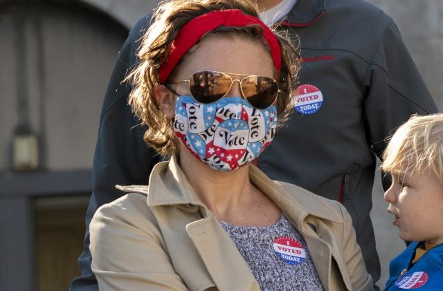 PHILADELPHIA, PA - OCTOBER 17:  Nya Nelson wears a "Vote" themed mask due to the coronavirus pandemic and an "I VOTED TODAY" sticker while departing with her family after casting their early voting ballots at Roxborough High School on October 17, 2020 in Philadelphia, Pennsylvania.  With the election only a little more than two weeks away, a new form of in-person early voting by using mail ballots, enables millions of voters have already cast their ballots.  President Donald Trump won the battleground state of Pennsylvania by only 44,000 votes in 2016, the first Republican to do so since President George Bush in 1988.  (Photo by Mark Makela/Getty Images)