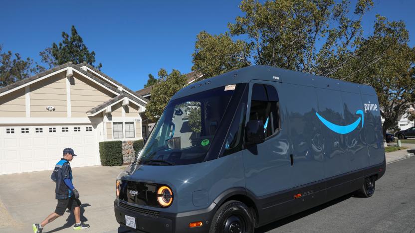 Driver David Gonzalez walks back to his truck after delivery in an Amazon Rivian Electric truck in Poway, California, U.S., November 16, 2022. REUTERS/Sandy Huffaker