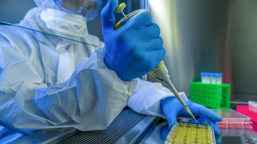 Researching vaccine to novel coronavirus 2019-nCoV. Close-up shot of a scientist preparing glass slide.