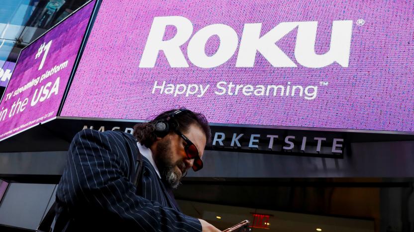 A man passes by a video sign display with the logo for Roku Inc, a Fox-backed video streaming firm, after the company's IPO at the Nasdaq Marketsite in New York, U.S., September 28, 2017. REUTERS/Brendan McDermid