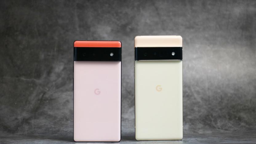 A Kinda Coral Pixel 6 and yellow/gold Pixel 6 Pro standing on a surface with their rear camera facing out.