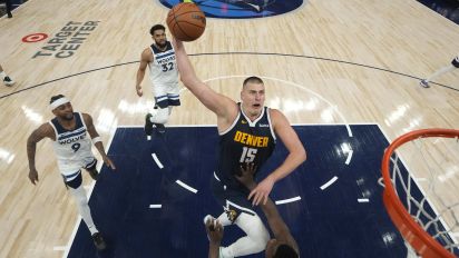 Associated Press - Denver Nuggets center Nikola Jokic (15) goes up for a shot as Minnesota Timberwolves guard Anthony Edwards, bottom, defends during the first half of Game 4 of an NBA basketball second-round playoff series, Sunday, May 12, 2024, in Minneapolis. (AP Photo/Abbie Parr)