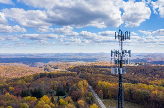 Aerial view of mobiel phone cell tower over forested rural area of West Virginia to illustrate lack of broadband internet service