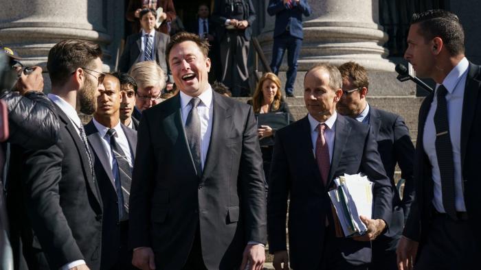 Elon Musk standing in front of a federal building, laughing maniacally, surrounded by men in suits.