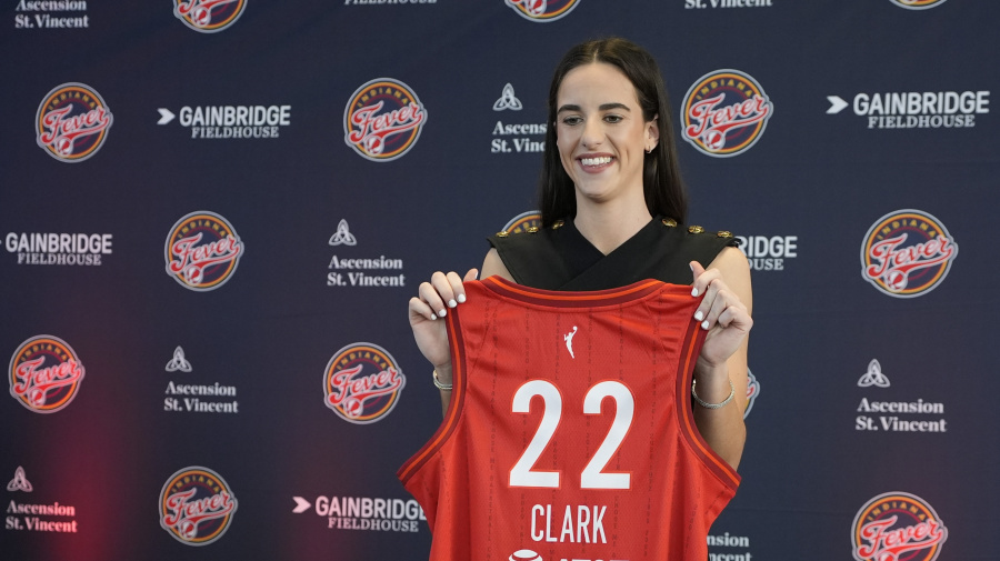 Associated Press - Indiana Fever's Caitlin Clark holds her jersey following a WNBA basketball news conference, Wednesday, April 17, 2024, in Indianapolis. (AP Photo/Darron Cummings)