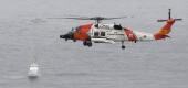 A U.S. Coast Guard helicopter flies over boats searching the area where a boat capsized Sunday just off the San Diego coast. (Denis PoroyAP)
