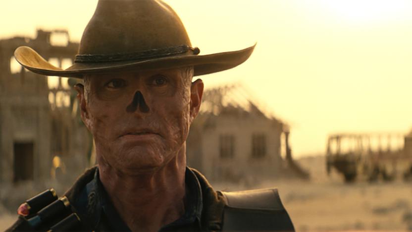 Closeup of Walton Goggins as The Ghoul in Prime Video’s Fallout series. He stares pensively in front of an abandoned town in a desert wasteland.
