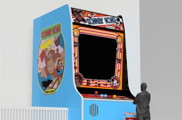 A large Donkey Kong arcade cabinet is shown with a black human figure standing at a smaller control panel in front of it.