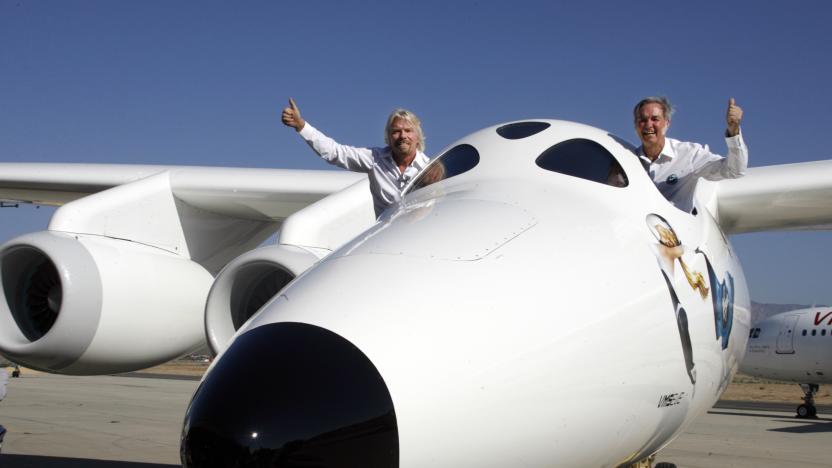 Virgin Group's Founder billionaire Richard Branson (L) and Burt Rutan, president of Scaled Composites, wave from the window of Virgin Galactic's mothership WhiteKnightTwo during its public roll-out in Mojave, California July 28, 2008. The twin fuselage aircraft WhiteKnightTwo will carry SpaceShipTwo to launch commercial passengers into space.  REUTERS/Fred Prouser  (UNITED STATES)