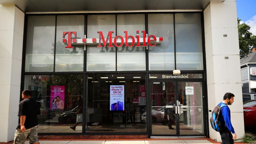 ARLINGTON, VA - AUGUST 18:  People walk past the front of a T-Mobile retail store on August 18, 2021 in Arlington, Virginia. T-Mobile announced Wednesday that a data breach exposed the personal information of 7.8 million current customers and 40 million people who had applied for credit. (Photo by Chip Somodevilla/Getty Images)