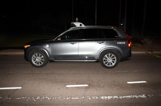 FILE - This file photo provided by the Tempe Police Department shows an Uber SUV after hitting a woman on March 18, 2018, in Tempe, Ariz. Nearly eight months after one of its autonomous test vehicles hit and killed an Arizona pedestrian, Uber wants to resume testing on public roads. The company has filed an application with the Pennsylvania Department of Transportation to test in Pittsburgh, and it has issued a lengthy safety report pledging to put two human backup drivers in each vehicle and take a raft of other precautions to make the vehicles safe. Company officials acknowledge they have a long way to go to regain public trust after the March 18 crash in Tempe, Arizona, that killed Elaine Herzberg, as she crossed a darkened road outside the lines of a crosswalk. (Tempe Police Department via AP, File)