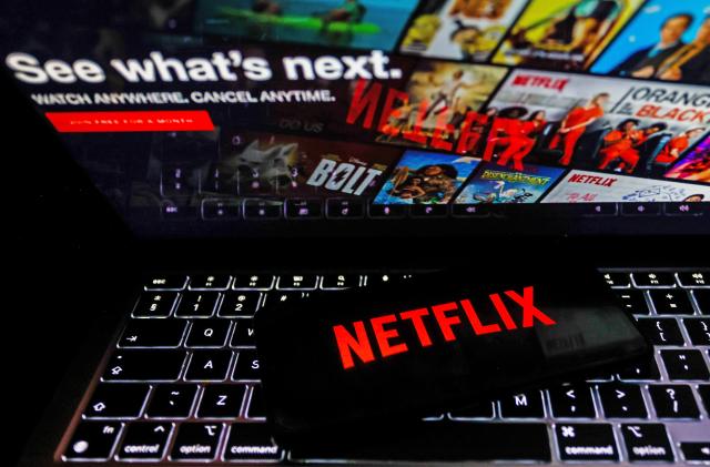 Netflix logo is displayed on a mobile phone screen with Netflix website in a background for illustration photo. Krakow, Poland on January 23, 2023. (Photo by )