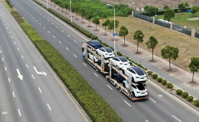 SHANGHAI, CHINA - JULY 11: Aerial view of new-energy vehicles sitting on a truck at Tesla Shanghai Gigafactory of Lingang New Area on July 11, 2021 in Shanghai, China. (Photo by VCG/VCG via Getty Images)