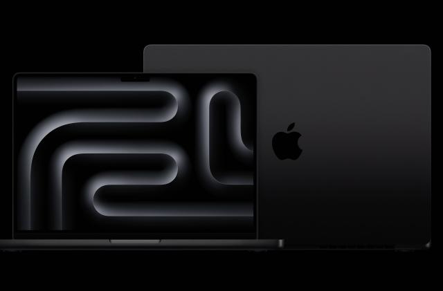 MacBook Pro in Space Black against a black background