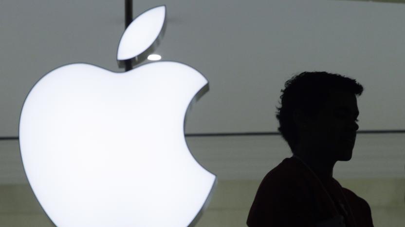 FILE - In this Dec. 7, 2011 file photo, a person stands near the Apple logo at the company's new store in Grand Central Terminal in New York. Apple’s iPhone sales soared yet again in the past quarter, but didn’t grow as rapidly as analysts anticipated, a sign the company’s momentum may be slowing amid supply shortages that have made it more difficult to meet the demand for a wide range of products. Although the company’s quarterly results released Thursday, Oct. 27, 2021 served as evidence of its products’ continuing success, they also indicated Apple isn’t immune to the supply headaches. (AP Photo/Mark Lennihan, File)