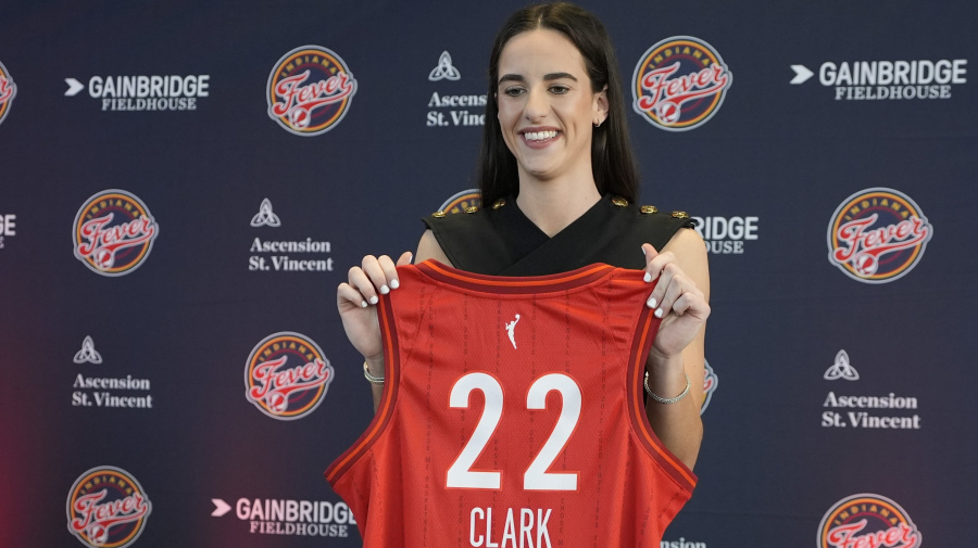 Associated Press - Indiana Fever's Caitlin Clark holds her jersey following a WNBA basketball news conference, Wednesday, April 17, 2024, in Indianapolis. (AP Photo/Darron Cummings)