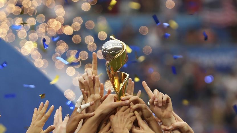 FILE - In this July 7, 2019, file photo, the United States players hold the trophy as they celebrate winning the Women's World Cup final soccer match against The Netherlands at the Stade de Lyon in Decines, outside Lyon, France. The 2023 Women's World Cup will be spread across nine cities in Australia and New Zealand. (AP Photo/Francisco Seco, File)