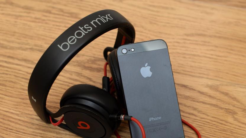 General view of a pair of beats Mixr headphones alongside an Apple iPhone 5, as Apple will make the most expensive acquisition in its history, after confirming a deal to buy Dr Dre's Beats Electronics for 3 billion dollars (&pound;1.78 billion).   (Photo by Andrew Matthews/PA Images via Getty Images)