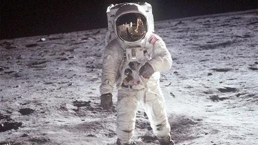 Archival photo of Neil Armstrong (in spacesuit) on the Moon’s surface in 1969.