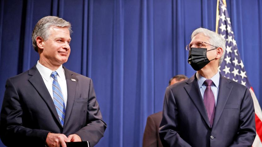 FBI Director Christopher Wray and U.S. Attorney General Merrick Garland face reporters as they announce charges against a suspect from Ukraine and a Russian national over a July ransomware attack on an American company, during a news conference at the Justice Department in Washington, U.S., November 8, 2021. 