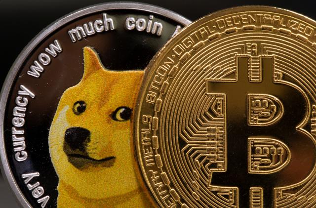 Representations of the virtual currency Dogecoin and Bitcoin are seen in this illustration taken June 16, 2021. REUTERS/Dado Ruvic/Illustration