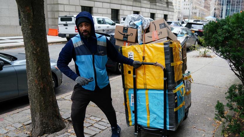 An Amazon delivery person pulls a cart full of packages in the Manhattan borough of New York City, New York, U.S., December 10, 2021.  REUTERS/Carlo Allegri