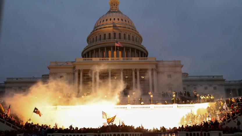 An explosion caused by a police munition is seen while supporters of U.S. President Donald Trump riot in front of the U.S. Capitol Building in Washington, U.S., January 6, 2021.  Reuters photographer Leah Millis: "Thousands of supporters of then-President Donald Trump, a Republican, stormed the U.S. Capitol on Jan. 6 in a failed attempt to overturn the recent election and prevent Joe Biden, a Democrat, from becoming the next president. It was the worst attack on the seat of the U.S. government since the War of 1812. I arrived at the west side of the U.S. Capitol before the Trump supporters overwhelmed police lines, and I documented the chaos that ensued for the next seven hours. At one point I heard the crowd chanting "heave-ho" and thought they must be breaking in through the doors. I didn't want to risk getting crushed or injured by the massive crowd, which was hostile toward members of the media and had already assaulted several of my colleagues that day. I chose to risk climbing some scaffolding that had been erected for the upcoming inauguration to give me a better view. The Capitol had already been breached via different entrances, but the fight for this entrance went on for hours. Capitol and D.C. Metropolitan police officers engaged in hand-to-hand combat with the mob of Trump supporters and in the process multiple officers were severely injured. Four people would die that day and a police officer attacked by protesters died the next day. Four officers later took their own lives. Eventually, law enforcement was able to successfully push the crowd back. At 5:04 p.m. to disperse the remaining protesters, they used a flash-bang grenade, which released a blinding light that illuminated the U.S. Capitol building. To me, the explosion of the grenade captured the violence and shock of the day: American citizens attacking and breaching their own country's Capitol building. The haunting sight of the American flag flying above the entire scene, casting a shadow onto