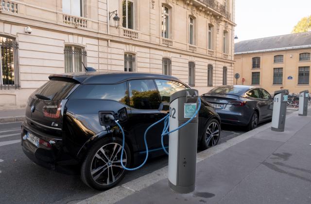 Paris, France - Aug 30, 2019: BMW i3, and a Tesla electric cars charching in Paris, France.