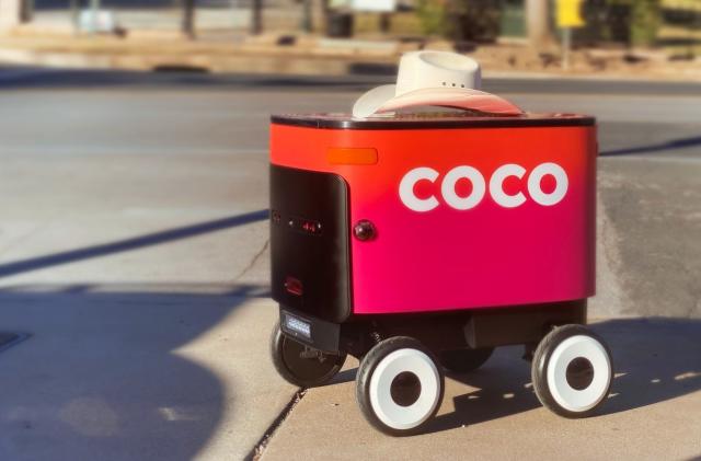 Coco delivery robot with a cowboy hat on top.