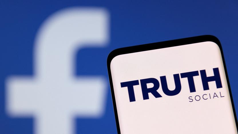 The Truth social network logo is seen on a smartphone in front of a display of the Facebook logo in this picture illustration taken February 21, 2022. REUTERS/Dado Ruvic/Illustration