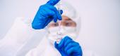 Scientist with vial of vaccine. (Getty Images)