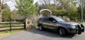 A sheriff's deputy is parked outside a residence where multiple people were fatally shot. (AP)