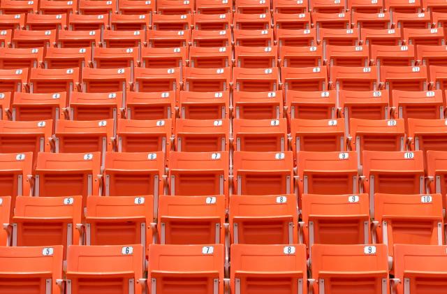 Stadium seat rows in sports arena for football or soccer game, public theatre, concert hall amphitheater with empty red audience chair for outdoor sporty recreational background