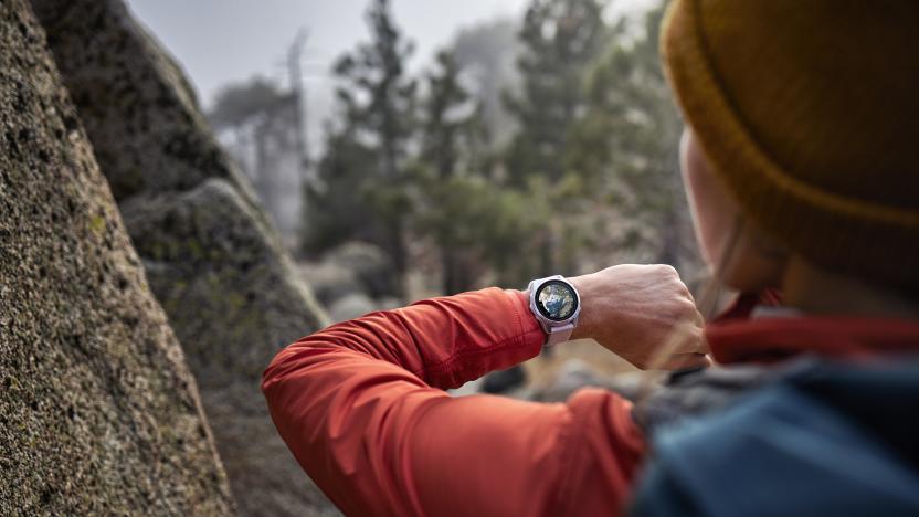 A woman wears an Epix Pro watch by Garmin out in the wild. 