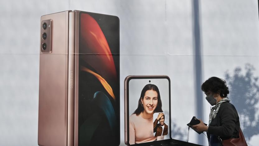 A woman walks past an advertisement for the Samsung Galaxy Z Fold2 and Z Flip smartphones at a Samsung Electronics store in Seoul on October 8, 2020 as the electronics giant flagged a leap of nearly 60 percent in third-quarter operating profits. (Photo by Jung Yeon-je / AFP) (Photo by JUNG YEON-JE/AFP via Getty Images)