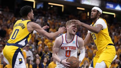 Associated Press - New York Knicks guard Donte DiVincenzo (0) drives between Indiana Pacers guard Tyrese Haliburton, left, and center Myles Turner, right, during the second half of Game 6 in an NBA basketball second-round playoff series, Friday, May 17, 2024, in Indianapolis. (AP Photo/Michael Conroy)