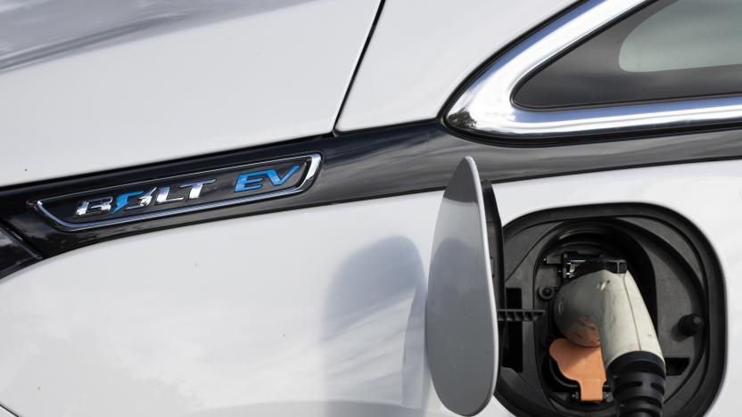 Tigard, OR, USA - Oct 6, 2021: Closeup of a Chevy Bolt EV electric car charging at a public charging station in a parking lot in Tigard, Oregon.