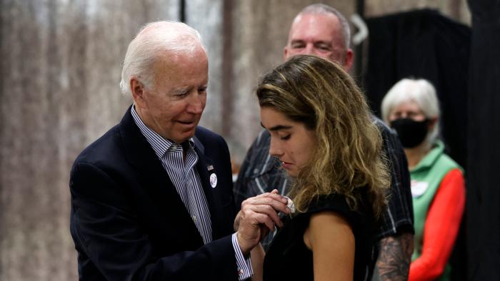 US President Joe Biden placed an 'voted' sticker on granddaughter Natalie Biden after they voted early, in Wilmington, Delaware on October 29, 2022. - Natalie Biden is a first-time voter and daughter of the late Beau Biden. (Photo by TASOS KATOPODIS / AFP) (Photo by TASOS KATOPODIS/AFP via Getty Images)