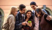 Teenager friends using the mobile phone outdoors