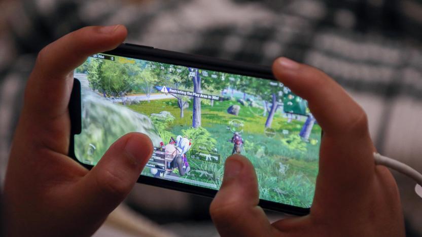 An Iraqi Kurdish youth plays the PUBG video game on his mobile phone in Arbil, the capital of the autonomous Kurdish region in northern Iraq, on May 1, 2021. - The mobile version of the game has become so popular in Iraq that the country's youth have been dubbed the "PUBG generation", as people across the country are spending hours every day on its virtual battleground, socialising via its live chat, playing competitively, or even falling in love. (Photo by SAFIN HAMED / AFP) (Photo by SAFIN HAMED/AFP via Getty Images)